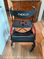 Front view of red Nexus rollator walker showing seat, backrest and wheels