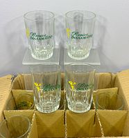 Front view of four glasses showing printed logos and design details