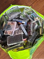 Green tote filled with assorted cassette tapes