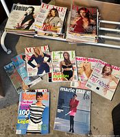 Overview of magazines spread out and stacked showing mix of titles
