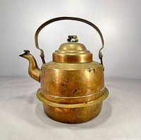 Front view of copper kettle showing spout, handle and body