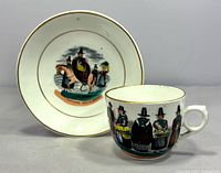 Cup and saucer front showing Welsh costume scenes