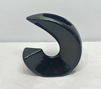 Front view of glossy black crescent ikebana vase