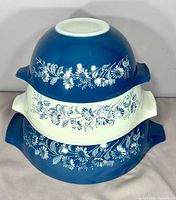 Stacked view of three Colonial Mist bowls showing pattern and colors