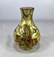 Front view showing floral relief and crackle metallic glaze