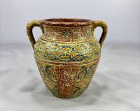Front view of small hand painted amphora jug vase showing handles and painted motifs