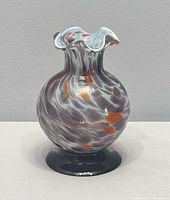 Full view of bud vase showing mottled pattern and pedestal base
