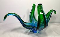 Oblique view showing blue and green cased glass bowl with stretched arms
