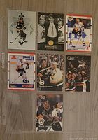 Front view of seven Mario Lemieux trading cards in a plastic sleeve