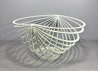 Angled view showing spiral wire structure of white metal bowl