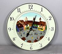 Front view of round Villeroy & Boch Design Naif wall clock
