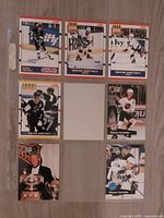 Seven Wayne Gretzky cards laid out on surface