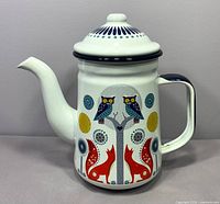 Front view of enamel coffee pot with Folklore Day design