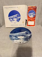 Front of plate, box, and pamphlet visible