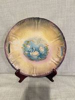 Front of platter showing hand-painted swan scene and handles