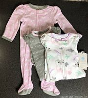 Three Cloud Island sleepers laid out showing prints and tag