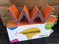 Box showing multicolor taco holder on top