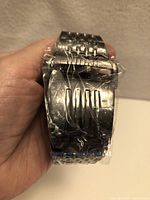 Watch front wrapped in plastic showing bracelet with concealed LED display
