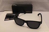 Front view of sunglasses with box and pouch