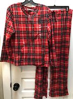 Full view of pajama set hanging, showing both top and pants