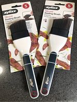 Front view showing two packaged Zyliss silicone basting brushes