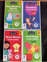 Front view of all four boxed flash card sets