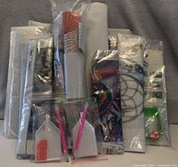 Front view of lot showing multiple sealed diamond painting kits with trays and pens