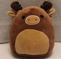 Front view of brown Squishmallow moose with tan belly and antlers