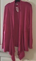 Front view of dark pink ribbed cardigan on hanger