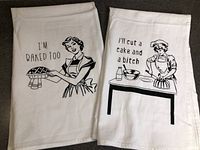 Both flour sack towels laid flat showing graphics and text