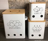 Front view of all three white metal canisters with bamboo lids showing Potatoes, Garlic, Onions graphics