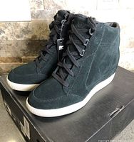 Full view of both boots on box