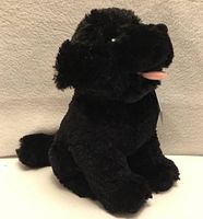 front left view of black plush Newfoundland dog with tongue visible, showing texture and form