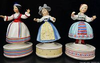 Front view of all three Schmid Girls of the World music boxes