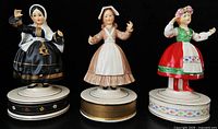 Front view of all three Schmid Girls of the World music boxes