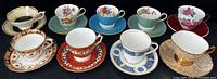 All nine bone china teacup and saucer sets arranged in a row