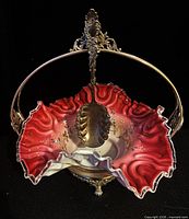Front view showing cased glass bowl, silverplate frame, spoon