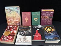 Eight assorted titles including Gabaldon hardcovers, reference and popular fiction