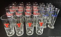 Group shot of all Coors Light, Tennents and some Harp glasses