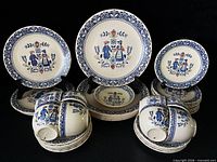 Front view of stacked and displayed plates, cups, saucers and bowl