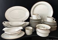 Group view of Dansk Brown Mist stoneware and TK Thuny porcelain pieces