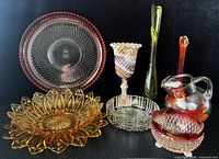 Group shot of all nine glass pieces showing sizes, colors, and styles