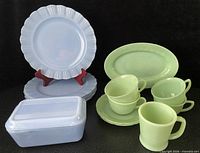 Group shot showing all blue Pyrex plates, refrigerator dish with lid and green Fire King pieces