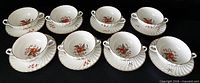 Eight bowl and saucer sets displayed