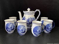 Coffee pot with six matching mugs displayed