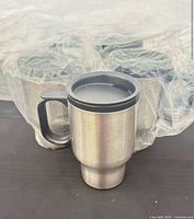 Front view of stainless steel travel mug with others wrapped behind