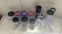 Full set of Magic Bullet cups, party mugs with colored rings, short and tall cups, stainless travel cup, lids and collar