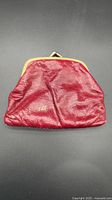 Front view of red leather kiss-lock coin purse
