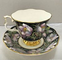 Teacup on saucer, front view showing pattern and gold trim