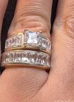 Both rings stacked on finger showing centre stone and eternity band